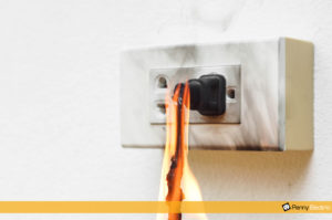 Burnt melted electrical outlet with burning power cable