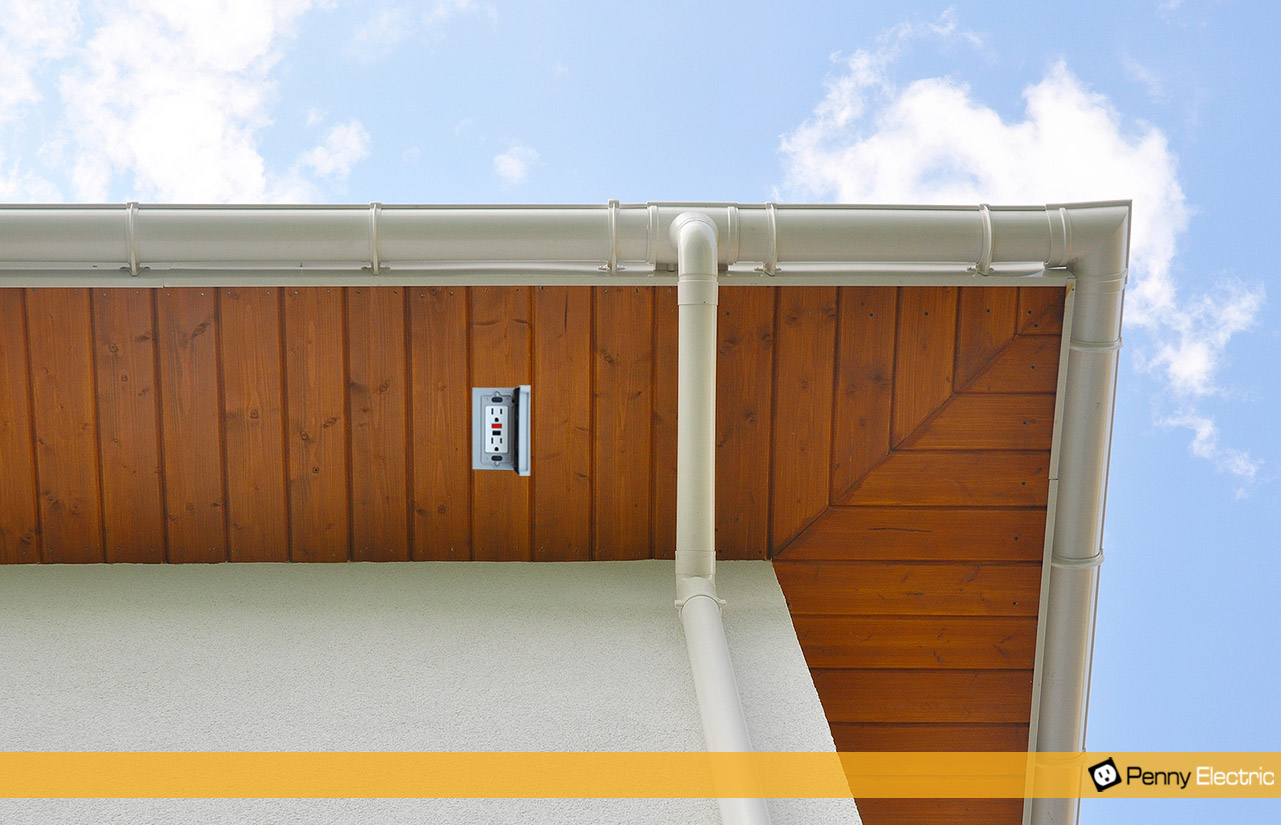 Power outlet in with weather resistant cover installed in soffit.